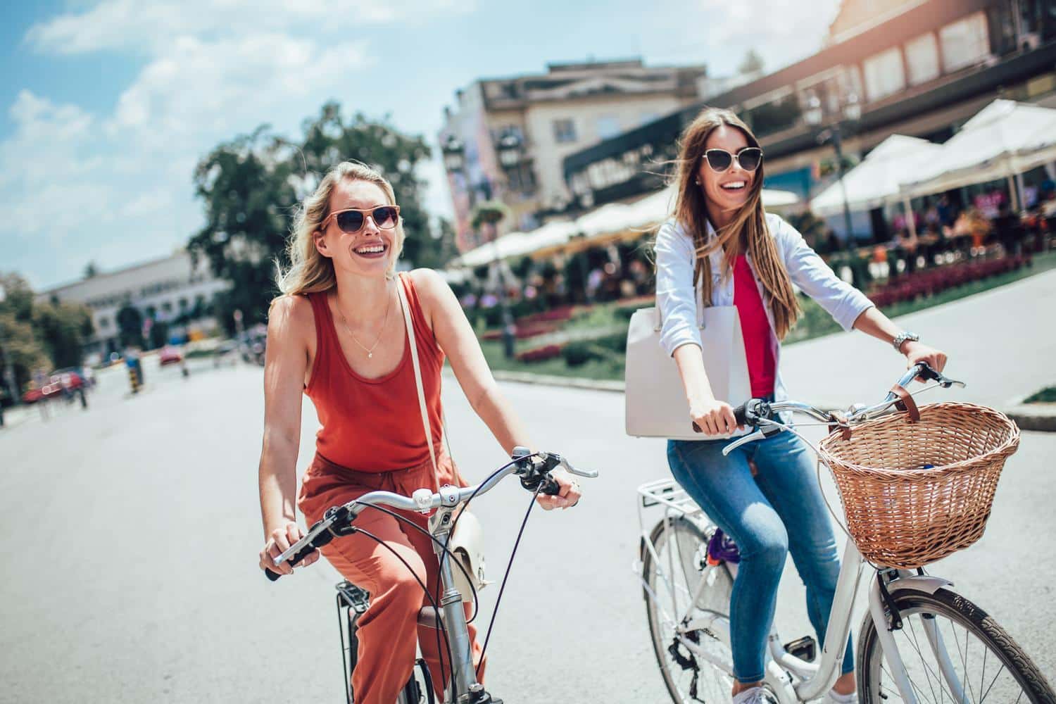 Two beautiful women shopping on bike in the city Two women riding bikes at Austin Landing